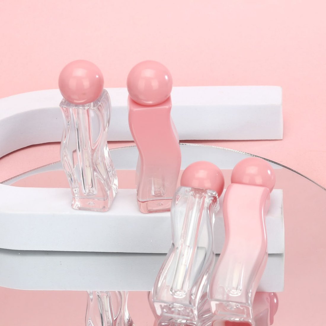Velora lip oil and lip gloss caps, close detail